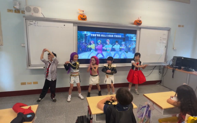 ‘K-Pop Demon Hunters' was a popular costume this year. Here the Grade 1 students showing off their dance moves for their classmates!